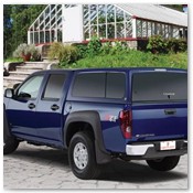 Blue Truck Parked in Front of Greenhouse