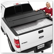 Woman Displaying Tonneau Cover on White Truck