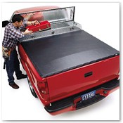 Man Removing Toolbox from Bed of Red Truck
